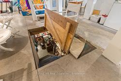 Crawlspace access via floor hatch in LR -