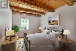 Cottage Main Bedroom. Image is virtually staged -