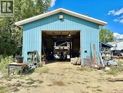 Rear of shop, drive-thru 12 by 12 bay doors allow for easy access of vehicles to and from the shop to the side bay door of the main building -