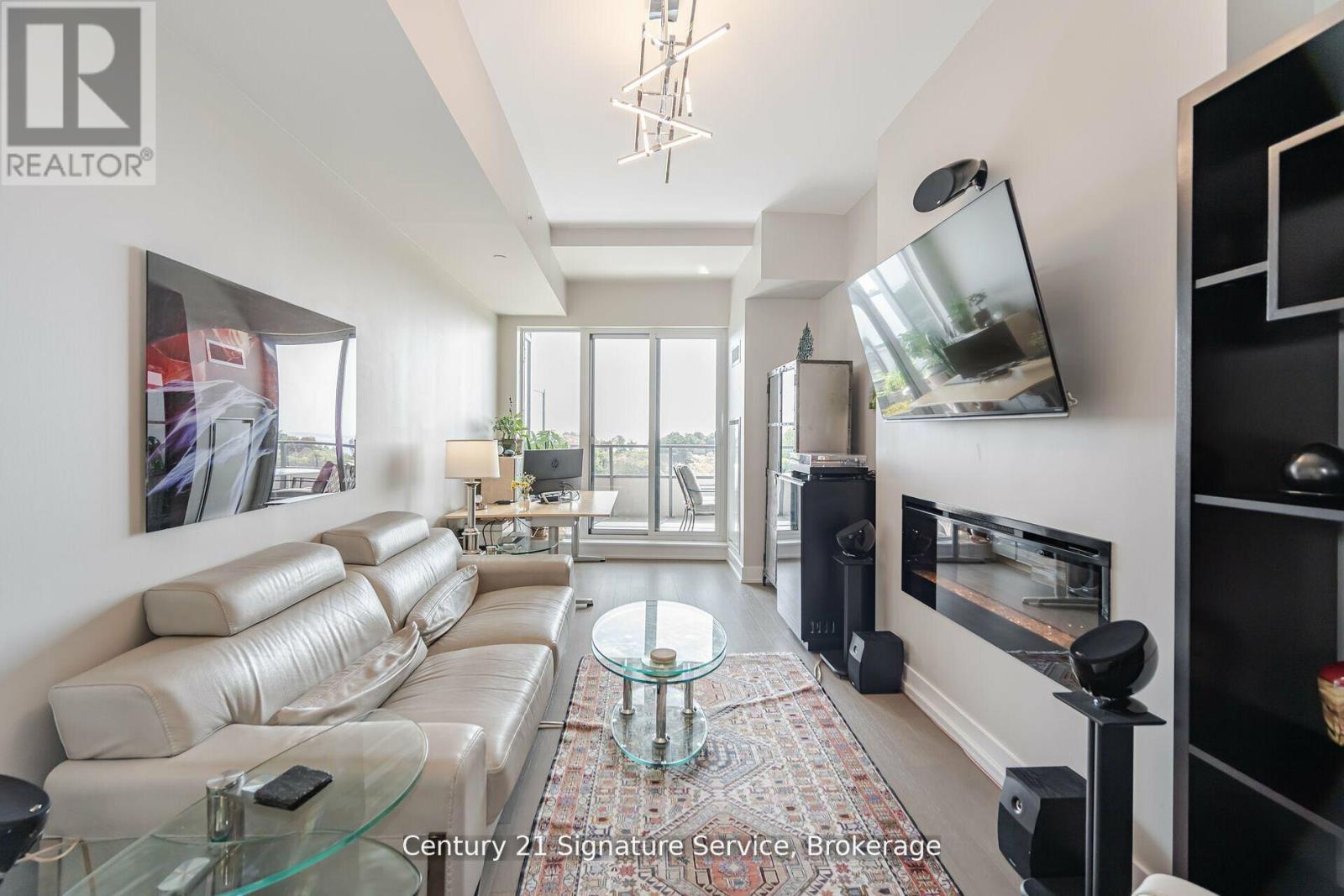 312 - 20 Shore Breeze Drive, Toronto, ON - Indoor Photo Showing Living Room With Fireplace