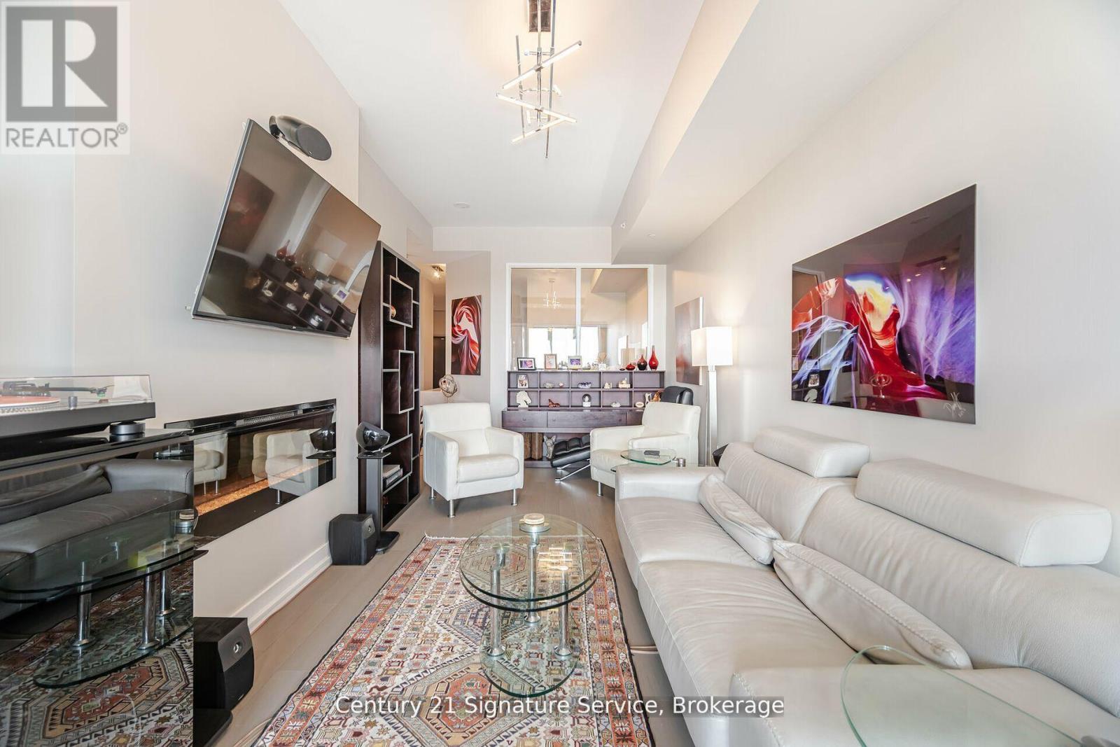 312 - 20 Shore Breeze Drive, Toronto, ON - Indoor Photo Showing Living Room With Fireplace