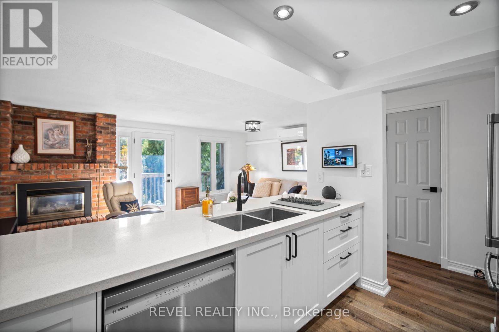 3 - 2058 Brant Street, Burlington, ON - Indoor Photo Showing Kitchen With Fireplace With Double Sink