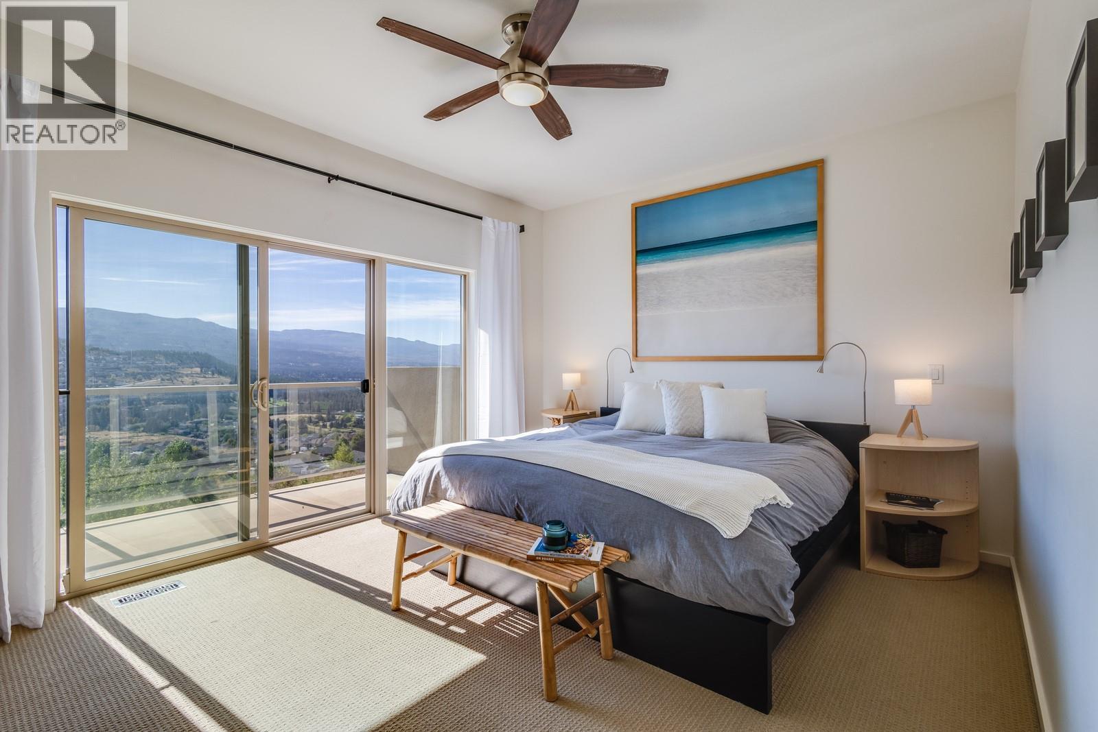 Large primary bedroom with access to the upstairs balcony - 1040 Henderson Drive, Kelowna, BC - Indoor Photo Showing Bedroom