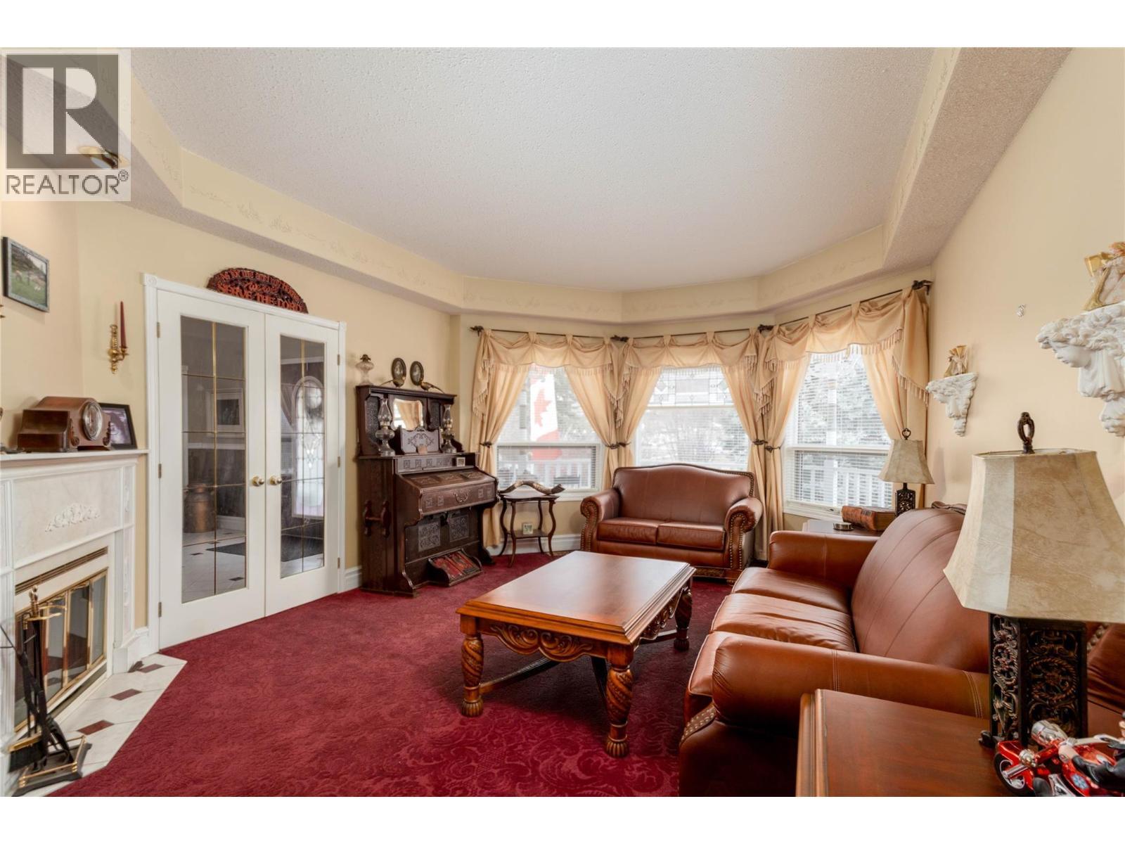 Living Room Main - 6655 Cosens Bay Road, Coldstream, BC - Indoor Photo Showing Living Room With Fireplace