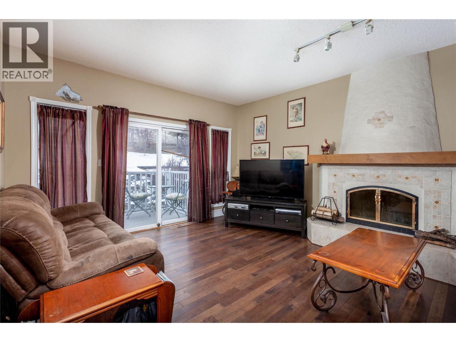 Family Room Main - 6655 Cosens Bay Road, Coldstream, BC - Indoor Photo Showing Living Room With Fireplace