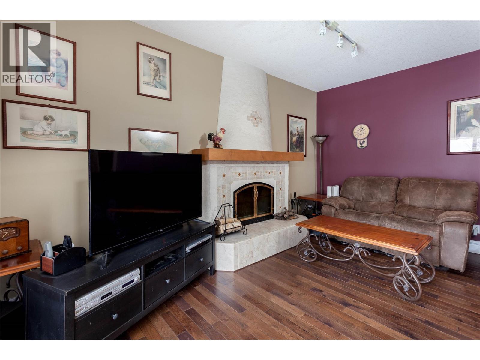 Family Room Main - 6655 Cosens Bay Road, Coldstream, BC - Indoor Photo Showing Living Room With Fireplace
