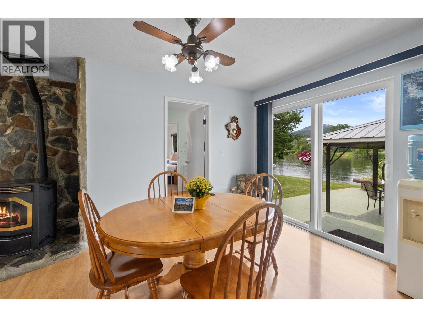 7088 97A Highway, Grindrod, BC - Indoor Photo Showing Dining Room With Fireplace