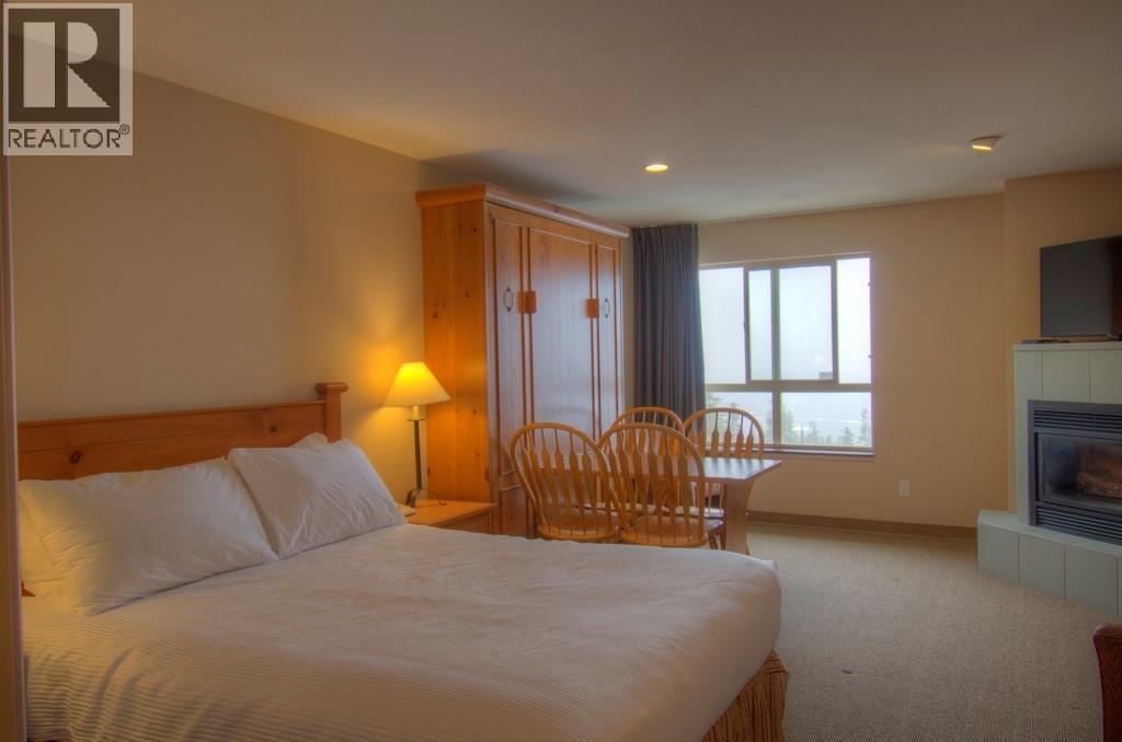 Unit 328 - 5340 Big White Road Unit# 328, Big White, BC - Indoor Photo Showing Bedroom With Fireplace