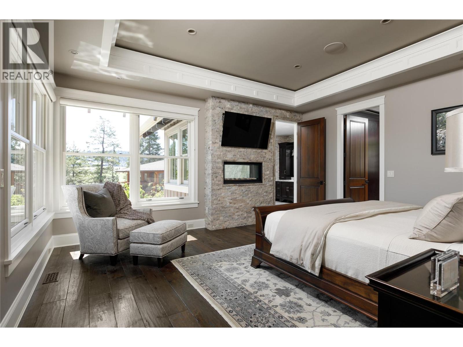 622 Jigger Place, Vernon, BC - Indoor Photo Showing Bedroom With Fireplace