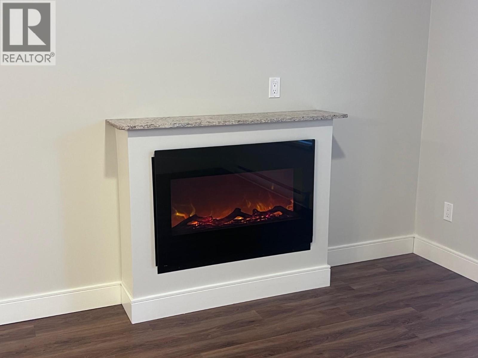 105 3684 Princess Crescent, Smithers, BC - Indoor Photo Showing Living Room With Fireplace