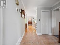 Entryway - coat closet and doors to 2 beds & bath -