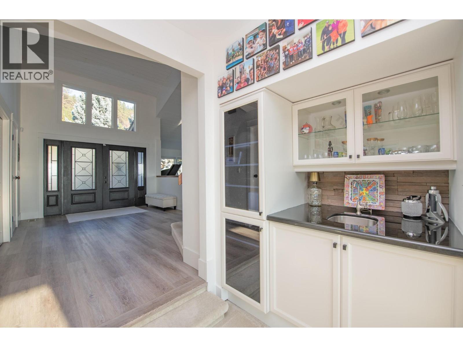 From entry to living room and wet bar - 702 Cypress Drive, Coldstream, BC - Indoor