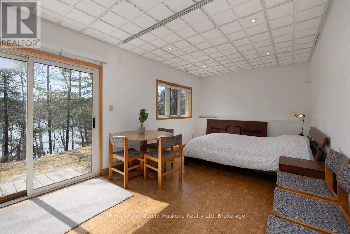 Lower level den area w walkout to lakeside - 38 Shebeshekong Estates Road S, Carling, ON - Indoor Photo Showing Bedroom