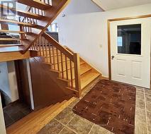 Main stairway; access to garage -