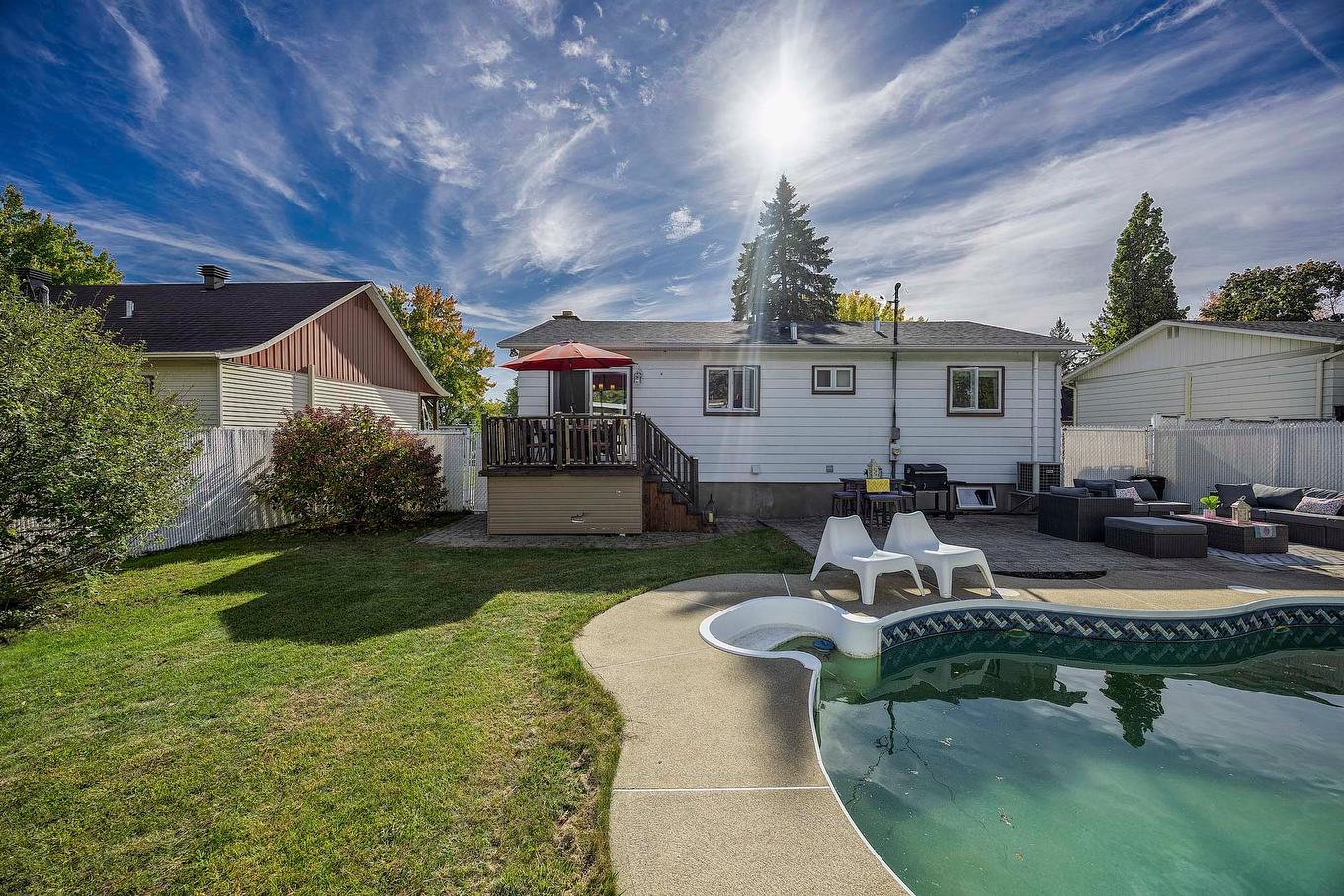 Pool - 447 Boul. Samson, Laval (Sainte-Dorothée), QC - Outdoor With In Ground Pool With Deck Patio Veranda