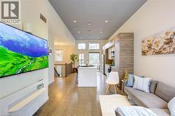 Living room featuring light wood finished floors and recessed lighting -