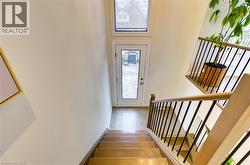 Stairs featuring wood finished floors and baseboards -