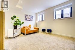 Living area with carpet and recessed lighting -