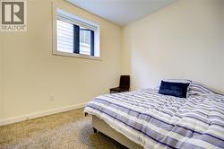 Carpeted bedroom featuring baseboards -