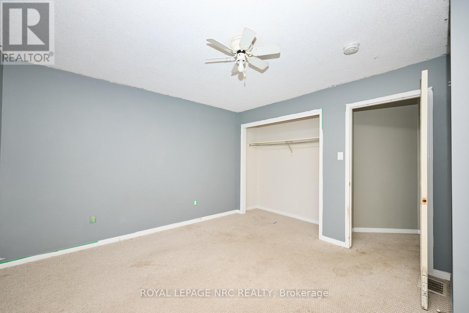 This bedroom has a double closet. - 14 Buss Court, Thorold (Confederation Heights), ON - Indoor Photo Showing Other Room