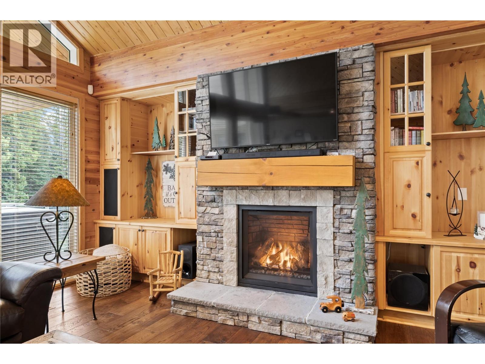 5946 Snow Pines Crescent Unit# A, Big White, BC - Indoor Photo Showing Living Room With Fireplace