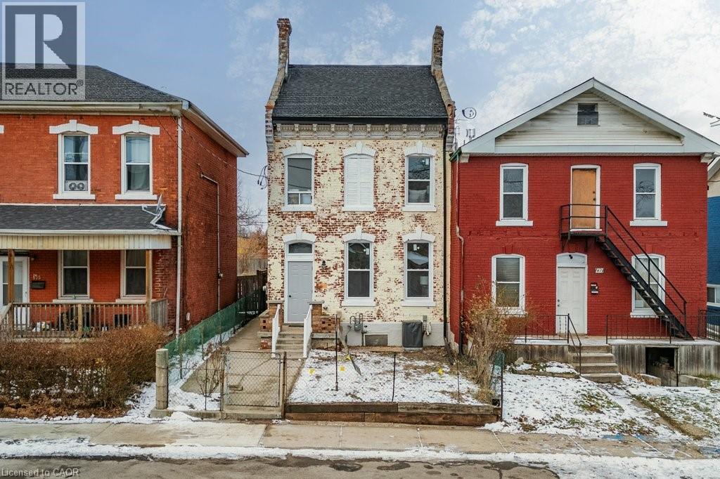 View of front of home featuring brick siding, a gate, and a fenced front yard - 125 Cathcart Street Unit# Lower, Hamilton, ON - Outdoor With Facade
