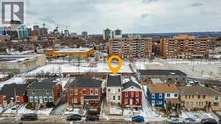 Snowy aerial view featuring a city view -