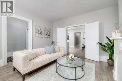 Living room with light wood-style flooring and baseboards -