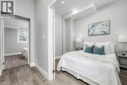Bedroom featuring wood finished floors and a closet -