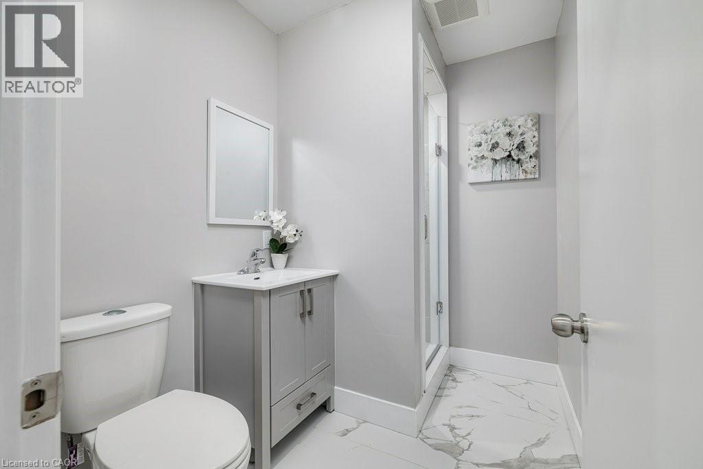 Full bath featuring vanity, light marble finish floors, and a stall shower - 125 Cathcart Street Unit# Lower, Hamilton, ON - Indoor Photo Showing Bathroom