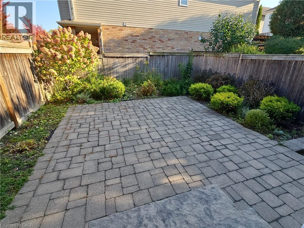 Fenced backyard with a patio area - 501 Blue Beech Boulevard Unit# B, Waterloo, ON - Outdoor