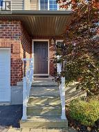 Entrance to property with brick siding and a garage -