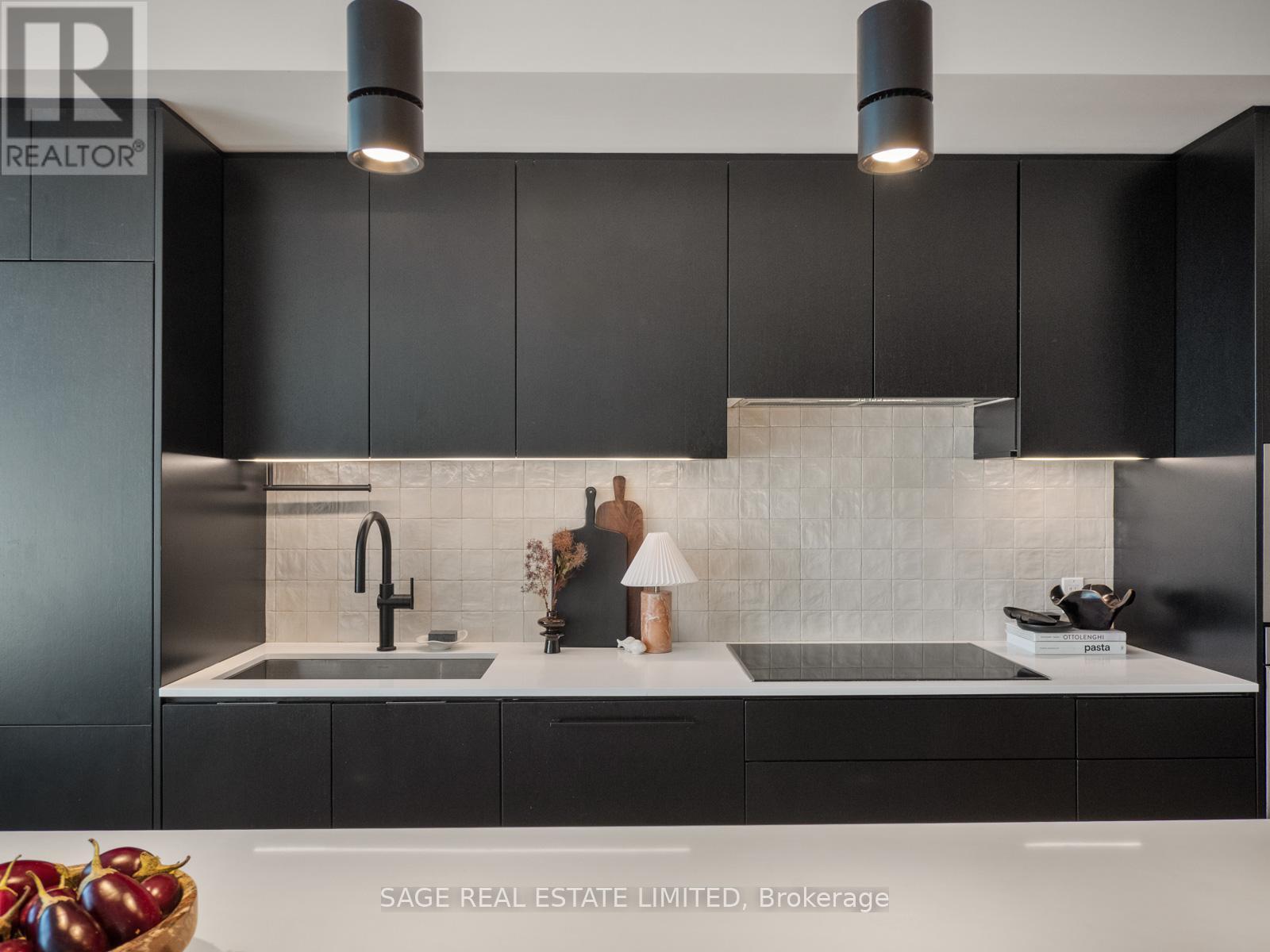 Sleek black kitchen design - Ph 621 - 899 College Street W, Toronto, ON - Indoor Photo Showing Kitchen