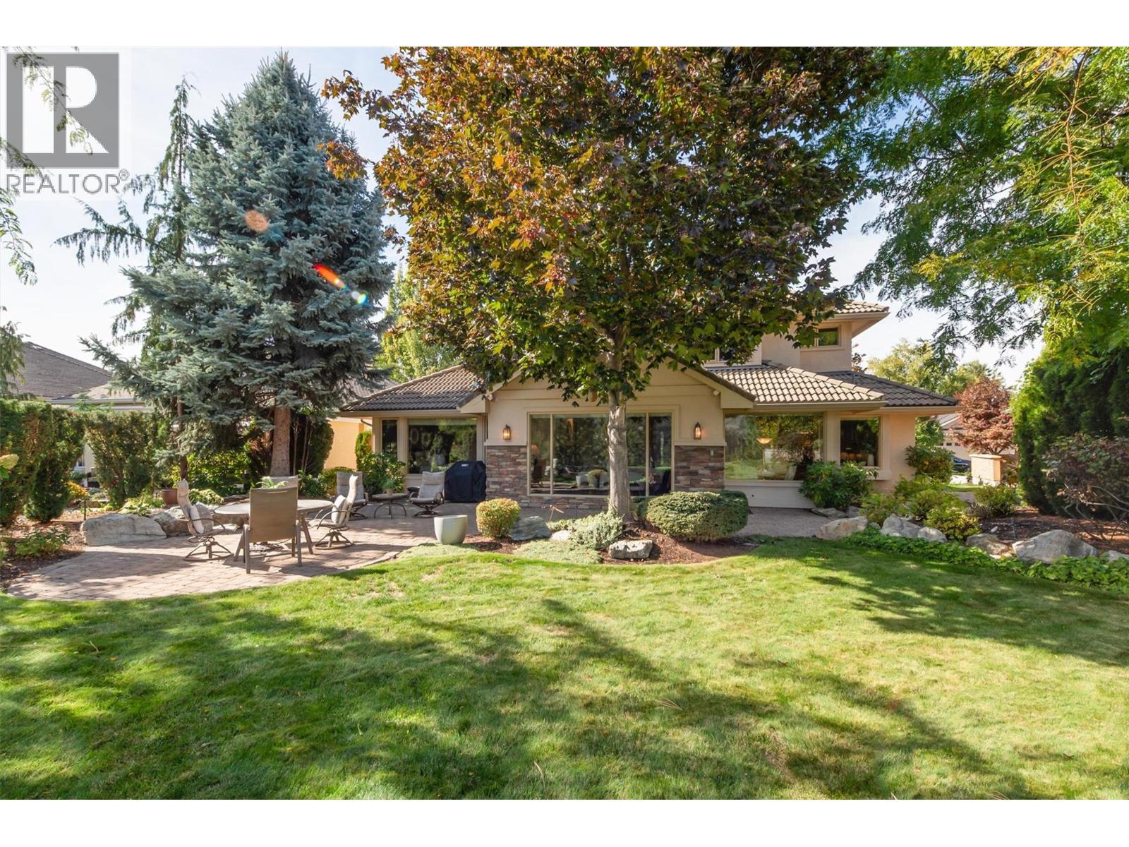 A private backyard with mature easy care landscaping. - 3875 Gallaghers Parkway, Kelowna, BC - Outdoor