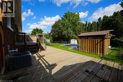 Deck featuring a storage unit and a fenced backyard -