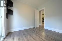 Empty room with light wood-style floors and baseboards -
