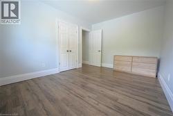 Unfurnished bedroom featuring wood finished floors and a closet -