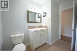 Half bath with vanity and light tile patterned floors -