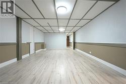 Finished below grade area with light wood finished floors and baseboards -
