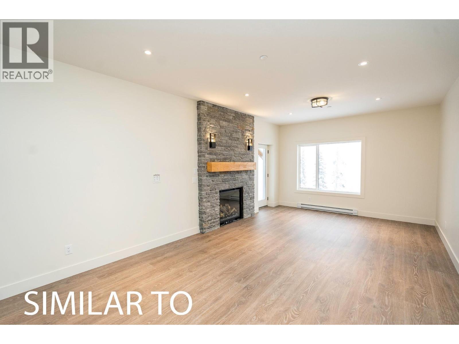 215B Grizzly Ridge Trail, Big White, BC - Indoor Photo Showing Living Room With Fireplace