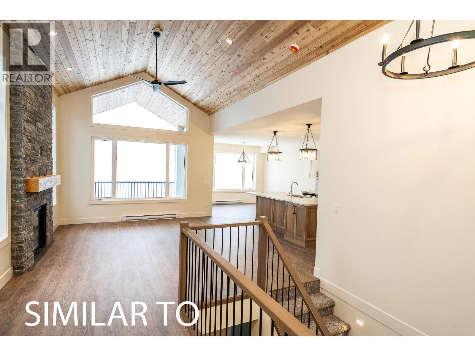 215B Grizzly Ridge Trail, Big White, BC - Indoor Photo Showing Other Room With Fireplace