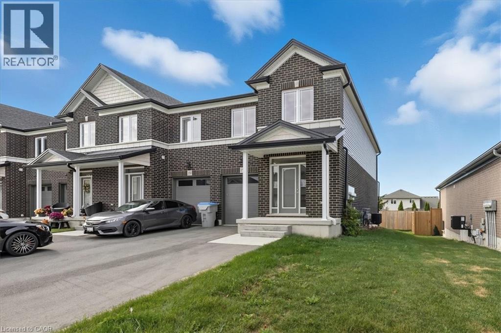Traditional-style home with brick siding, an attached garage, and driveway - 256 Keeso Lane, Listowel, ON - Outdoor