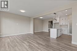 Unfurnished living room with light wood-style flooring, recessed lighting, a chandelier, and stairs -