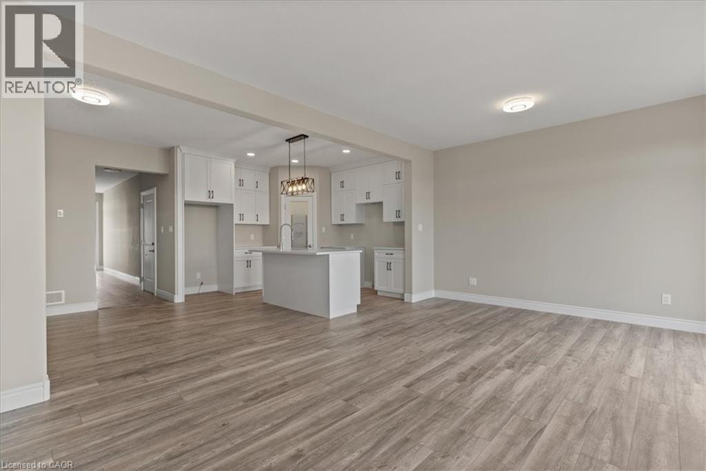 Unfurnished living room with light wood-style floors and recessed lighting - 256 Keeso Lane, Listowel, ON - Indoor Photo Showing Kitchen
