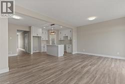 Unfurnished living room with light wood-style floors and recessed lighting -