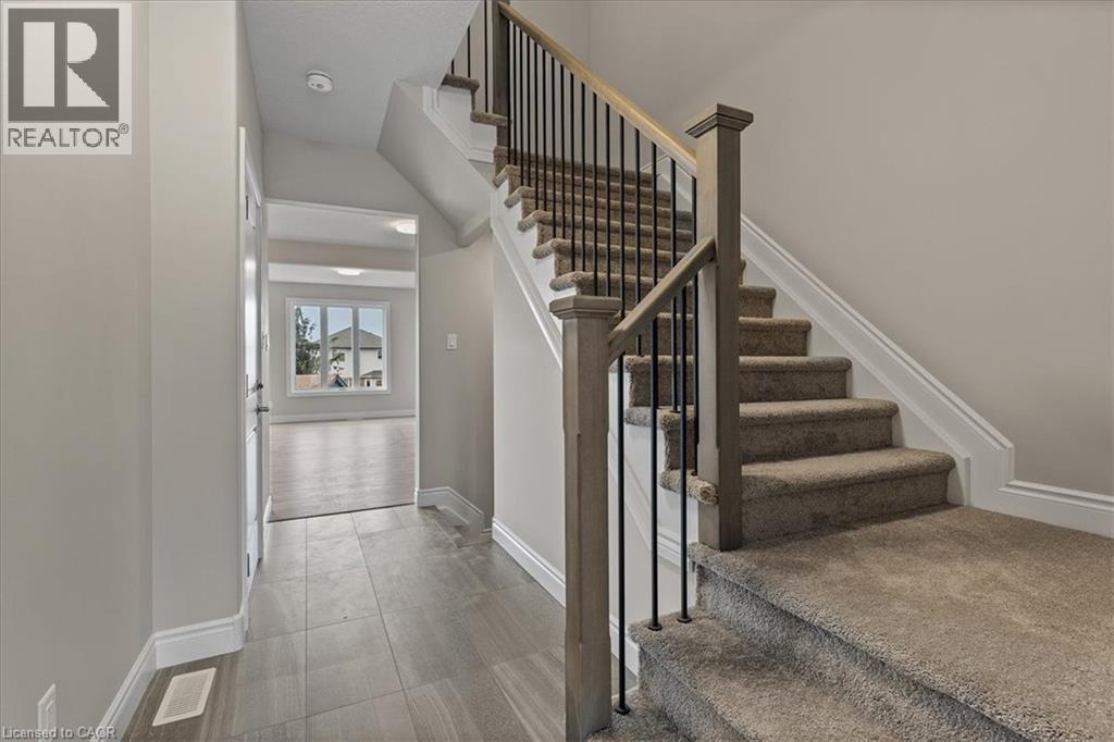 Staircase featuring baseboards - 256 Keeso Lane, Listowel, ON - Indoor Photo Showing Other Room
