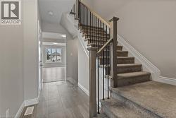 Staircase featuring baseboards -
