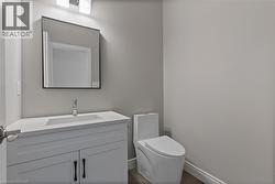 Half bathroom with vanity and toilet -