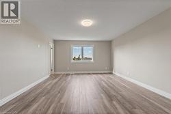 Unfurnished room with light wood-style floors and a textured ceiling -