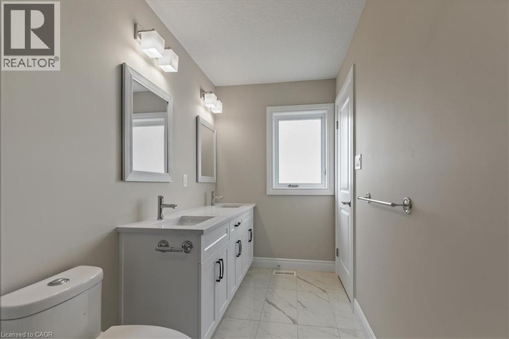 Bathroom with light marble finish floors and double vanity - 256 Keeso Lane, Listowel, ON - Indoor Photo Showing Bathroom